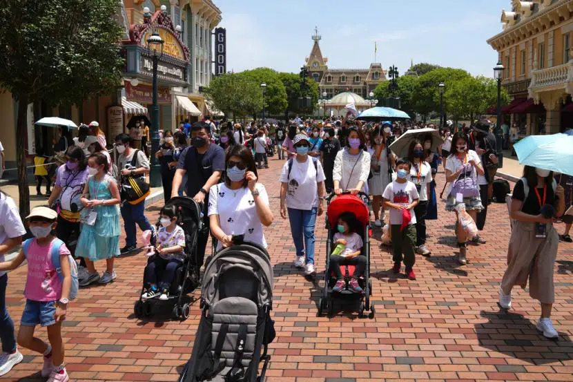 Pengunjung mengenakan masker berjalan di Hong Kong Disneyland Kamis 21 April 2022 Hong Kong Disneyland dibuka kembali untuk umum setelah ditutup akibat lonjakan infeksi COVID 19