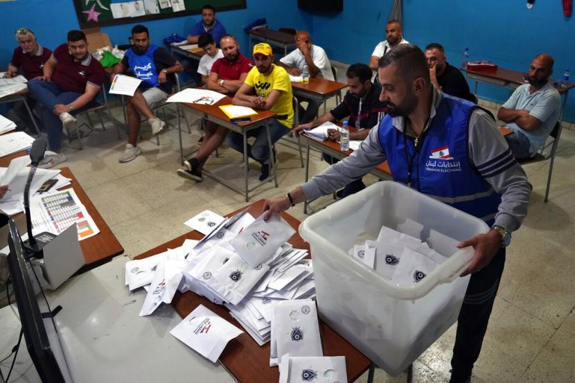 Petugas pemilu menghitung surat suara tak lama setelah tempat pemungutan suara ditutup di kota utara Tripoli Lebanon Minggu 15 Mei 2022 Warga Lebanon memilih parlemen baru hari Minggu dengan latar belakang krisis ekonomi yang mengubah negara dan rendahnya ekspektasi bahwa pemilu akan secara signifikan mengubah lanskap politik