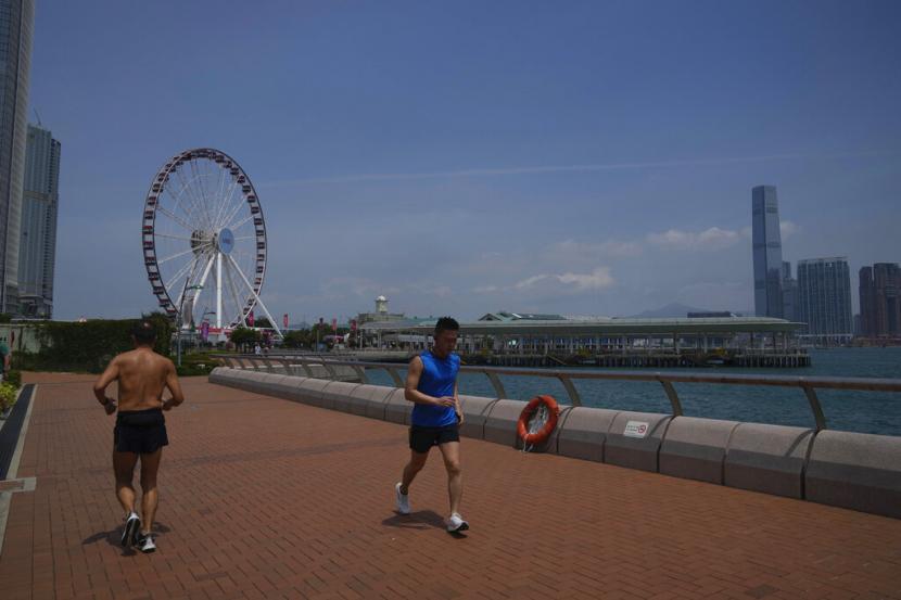 People run at a waterfront in Hong Kong Thursday May 5 2022