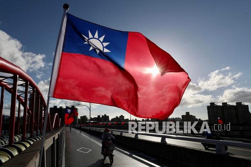 Orang orang melewati pemasangan bendera Taiwan menjelang perayaan Hari Nasional di Taipei Taiwan 6 Oktober 2021