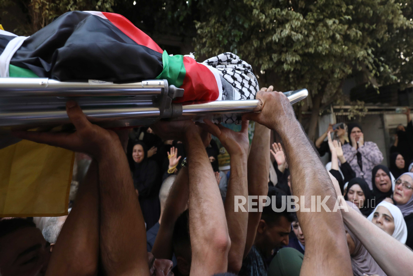 Warga Palestina membawa jenazah Fris Zaid yang berusia 14 tahun saat dilakukan pemakaman di kota Qalqilya di Tepi Barat Kamis 2772023
